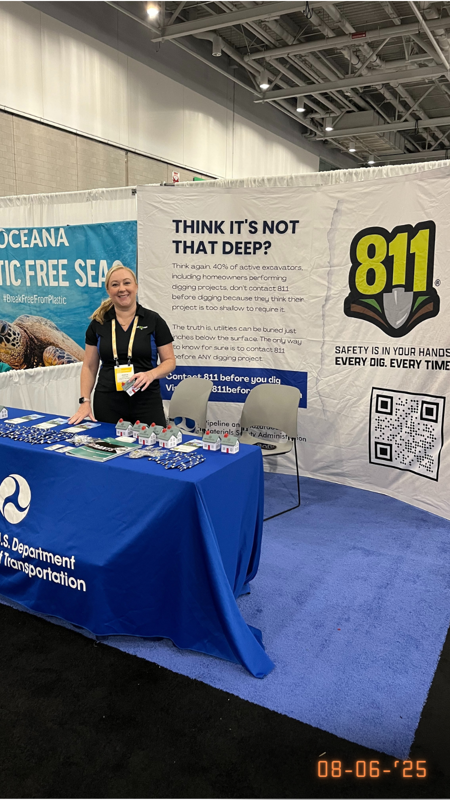 Photo of PHMSA representative standing in front of 811 display table